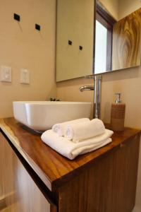 a bathroom with a tub and towels on a counter at Akbal Tulum in Tulum