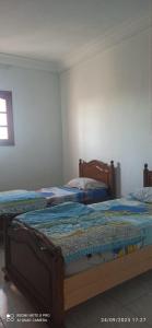 1 Schlafzimmer mit 3 Betten in einem Zimmer in der Unterkunft appartamenti Oueslati in Houmt Souk