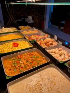 a buffet filled with lots of different types of food at Conde Hotel Maceió in Maceió
