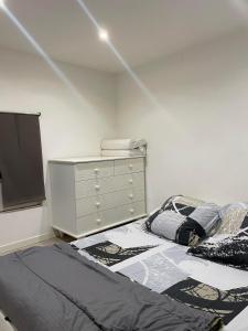 a bedroom with a bed and a dresser at Petit duplex gare Saint-Roch in Montpellier
