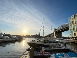a group of boats docked in a harbor with a bridge at Downtown 1BR Condo at Granville Strip near English Bay in Vancouver