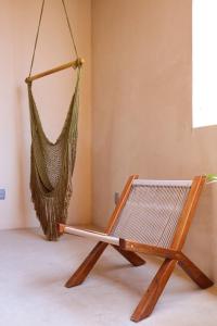 a hammock hanging from a wall in a room at Akbal Tulum in Tulum
