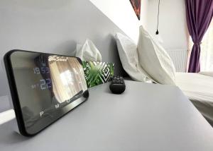 a cell phone sitting on a table in a bedroom at Mountain River Loft in Buşteni