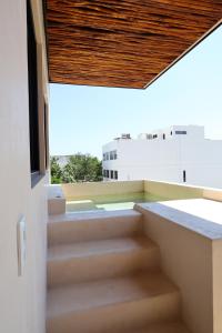 a view from the balcony of a building with stairs at Akbal Tulum in Tulum