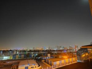 a view of a city at night with at Sea View Studio in Ajman 