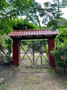 a red gate with a red roof at Surf City Town House in La Libertad