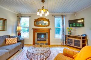 a living room with a couch and a fireplace at Historic Mapleton Cottage with River Views and Hot Tub in Mapleton