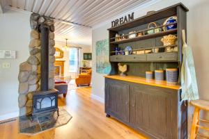 a kitchen with a wood stove in a room at Historic Mapleton Cottage with River Views and Hot Tub in Mapleton