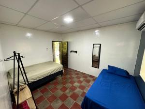 a room with two beds and a mirror on the wall at Surf City Town House in La Libertad