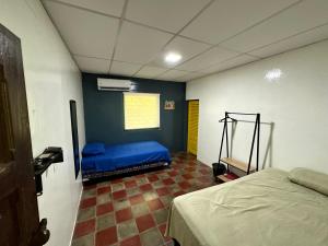 a bedroom with a blue bed in a room with at Surf City Town House in La Libertad
