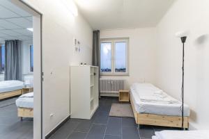 Tempat tidur dalam kamar di T&K Apartments 6 and 10 Room Apartment in Neuss for big Groups 22min to Fair DUS