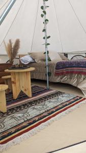 Zimmer mit einem Bett und einem Tisch in einem Zelt in der Unterkunft Killary Lodge in Cachanlo de Sidcay