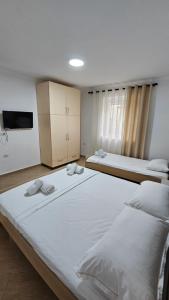 a bedroom with two beds with towels on them at Aliaj's Guest House in Berat