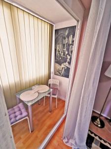 a small room with a table and a chair at Cozy Studio Athenee in Bucharest