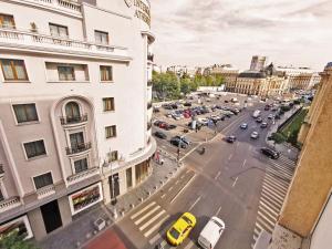 a view of a city street with cars and buildings at Cozy Studio Athenee in Bucharest