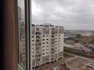 a view of a large apartment building from a window at Kings Millennium in Nairobi