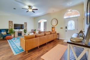 a living room with a couch and a tv at Tarpon Springs Family Getaway with Patio and Hot Tub! in Tarpon Springs