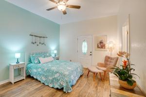 a bedroom with a bed and a chair and a ceiling fan at Tarpon Springs Family Getaway with Patio and Hot Tub! in Tarpon Springs