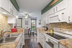 a kitchen with white cabinets and a sink at Townhome - Convenient Location in Houston