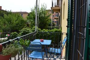 a blue table and chairs on a balcony at Alemanni54 - Apartment in Bologna