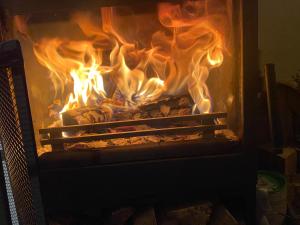 a fire is burning in a fireplace at Casa de Svana Liptov in Ružomberok
