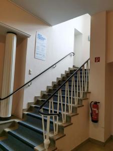 a staircase in a building with a fire extinguisher at Ferienwohnung 303 am Kasinopark in Georgsmarienhütte