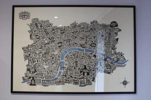 a painting of a map with a blue arrow at Lavish London Stay Near Wembley Stadium in London