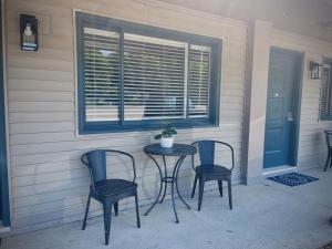 a table and chairs on a porch with a window at TeePee Room 15-Newly Renovated in Roscommon