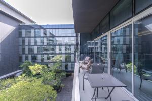 a balcony with chairs and a table on a building at City Walk Chic living 1 Bedroom apartment in Dubai