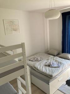 a small bedroom with a bed and a ladder at Casa de Svana Liptov in Ružomberok