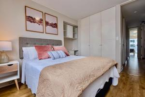a bedroom with a large bed and white cabinets at ALU Apartments - Miraflores Boardwalk, Wifi 70M in Lima