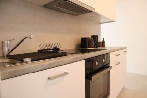 a kitchen with a sink and a stove at RheinMosel Glück 4 in Koblenz