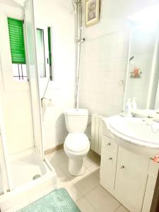 a white bathroom with a toilet and a sink at 3 bedrooms flat near of the beach in Barcelona