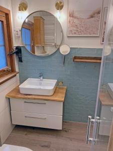 a bathroom with a sink and a mirror at Beach House in Schönberger Strand