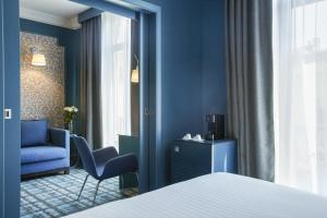 Postel nebo postele na pokoji v ubytování Grand Hôtel du Midi Montpellier - Opéra Comédie