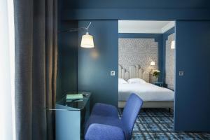 Postel nebo postele na pokoji v ubytování Grand Hôtel du Midi Montpellier - Opéra Comédie