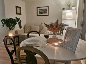 a dining room table with a glass of wine on it at Peaceful house in the heart of Glasgow city, close to Queen Elizabeth Hospital and Govan subway, Free Private Parking in Glasgow +4 photos