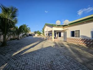 a cobblestone street in front of a building at My Place Guest House in Ho