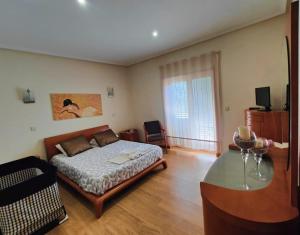 a bedroom with a bed and a glass table at Quinta da Libelinha Alojamento Local - Mirandela in Mirandela +42 photos