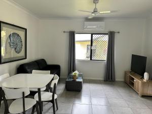 a living room with a table and chairs and a tv at Atherton Holiday Park in Atherton