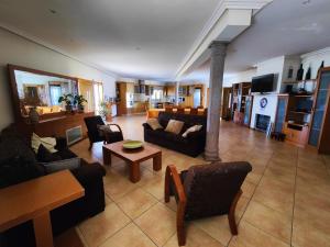 a large living room with couches and a table at Quinta da Libelinha Alojamento Local - Mirandela in Mirandela