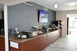 a kitchen with a counter with a microwave on it at Baymont by Wyndham Macon I-75 in Macon