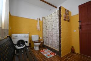 a small bathroom with a toilet and a sink at Mirador del Gallego in Santa Maria de Guia de Gran Canaria