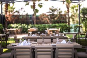 a wooden table with chairs and wine glasses on it at Best Western Premier Karsiyaka Convention & Spa Hotel in Izmir