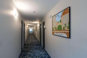 a hallway with a painting hanging on the wall at Rodeway Inn & Suites near Outlet Mall - Asheville in Asheville