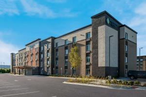 Un gran edificio de ladrillo con un reloj encima. en WoodSpring Suites Detroit Sterling Heights, en Sterling Heights