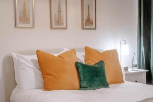 a white couch with four pillows on it at Mayfield Three - Central Harrogate Apartment in Harrogate