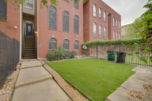a large brick building with a lawn in front of it at Houston Townhome By George Brown Convention Center in Houston