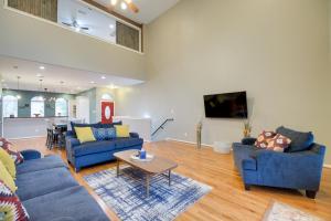 a living room with two blue couches and a table at Houston Townhome By George Brown Convention Center in Houston