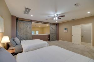 a bedroom with two beds and a ceiling fan at Houston Townhome By George Brown Convention Center in Houston